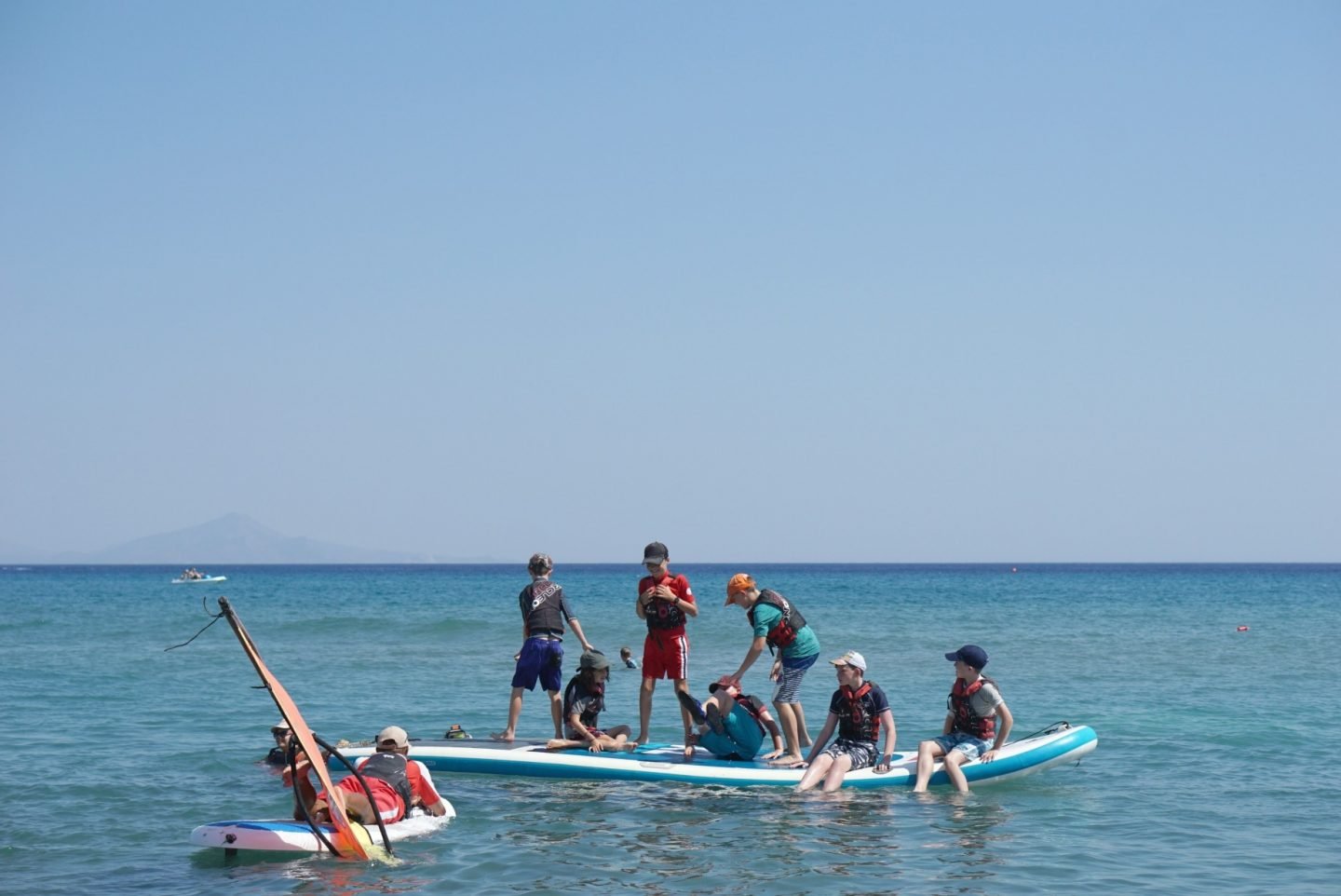 Learning to paddle board and windsurf in Greece for teens