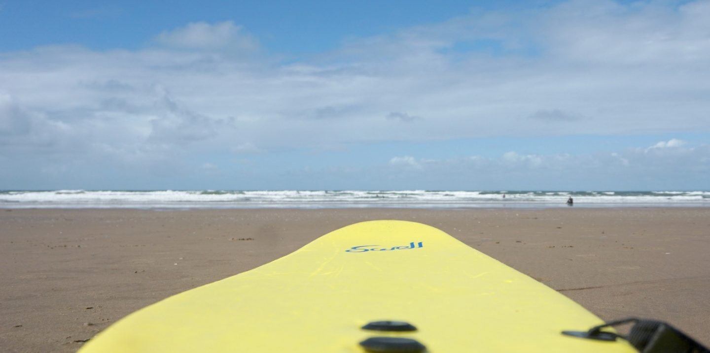 Where to get surfing lessons in Swansea Bay