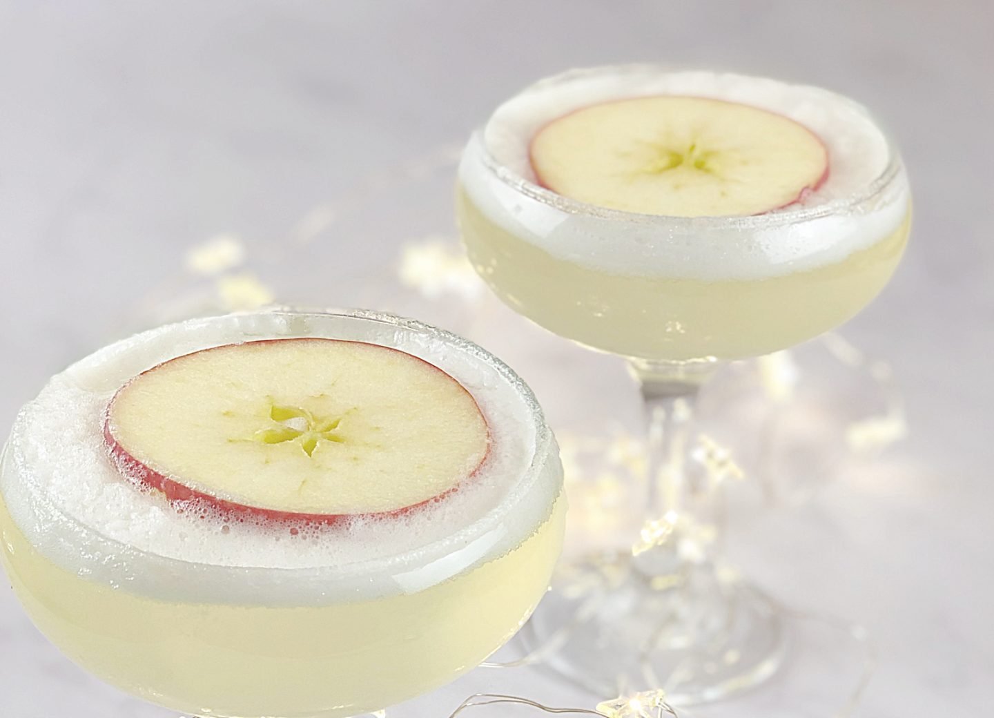 Gin and prosecco cocktail topped with elderflower foam, Easy Summer Cocktail Recipes to try for hot summers day.