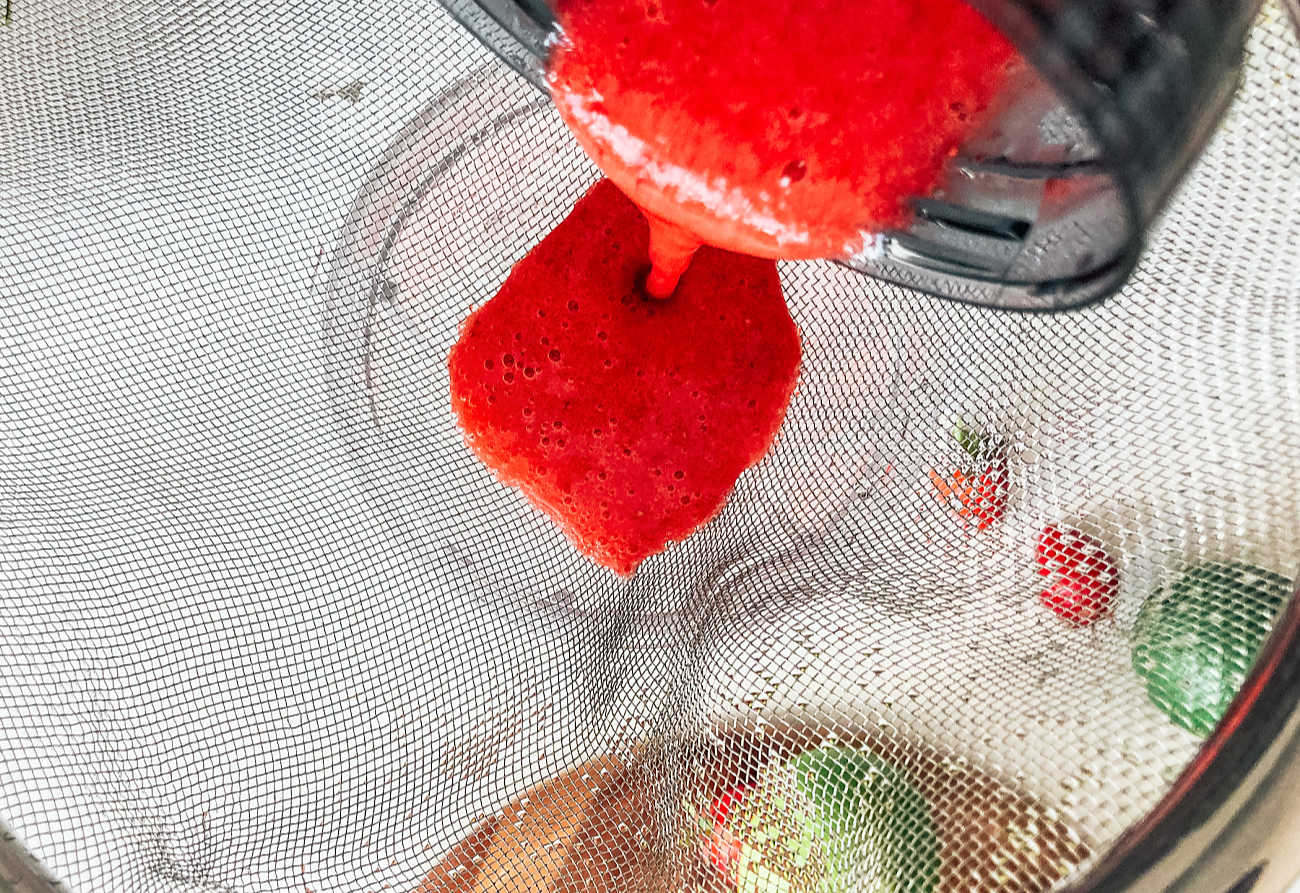Sieve strawberry juice once blended to get bits out