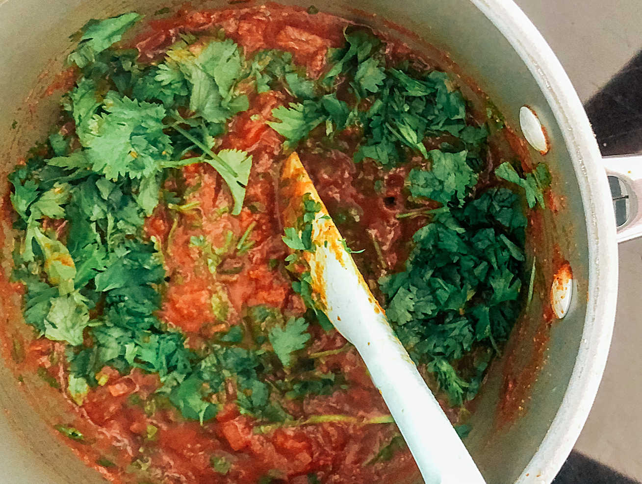 Add coriander and mix in before simmering to cook down and release the flavour