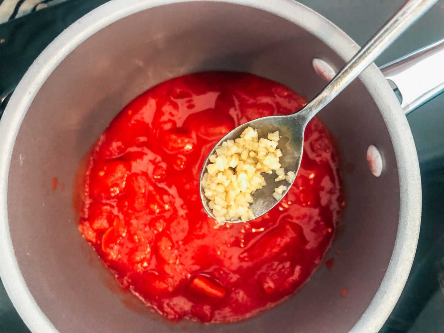 Add garlic to a base tomato sauce to make a Slimming World Italian Tomato Sauce Recipe For Pasta