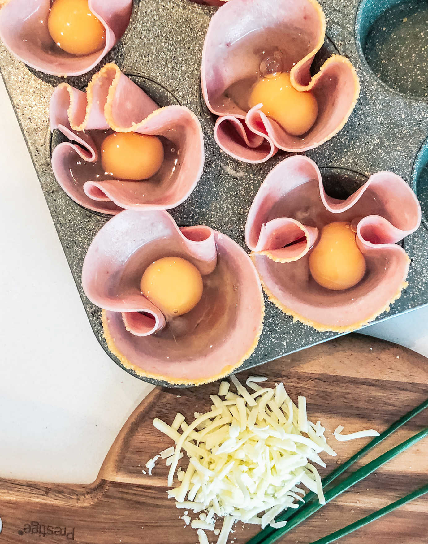 Crack an egg into each lined muffin tin