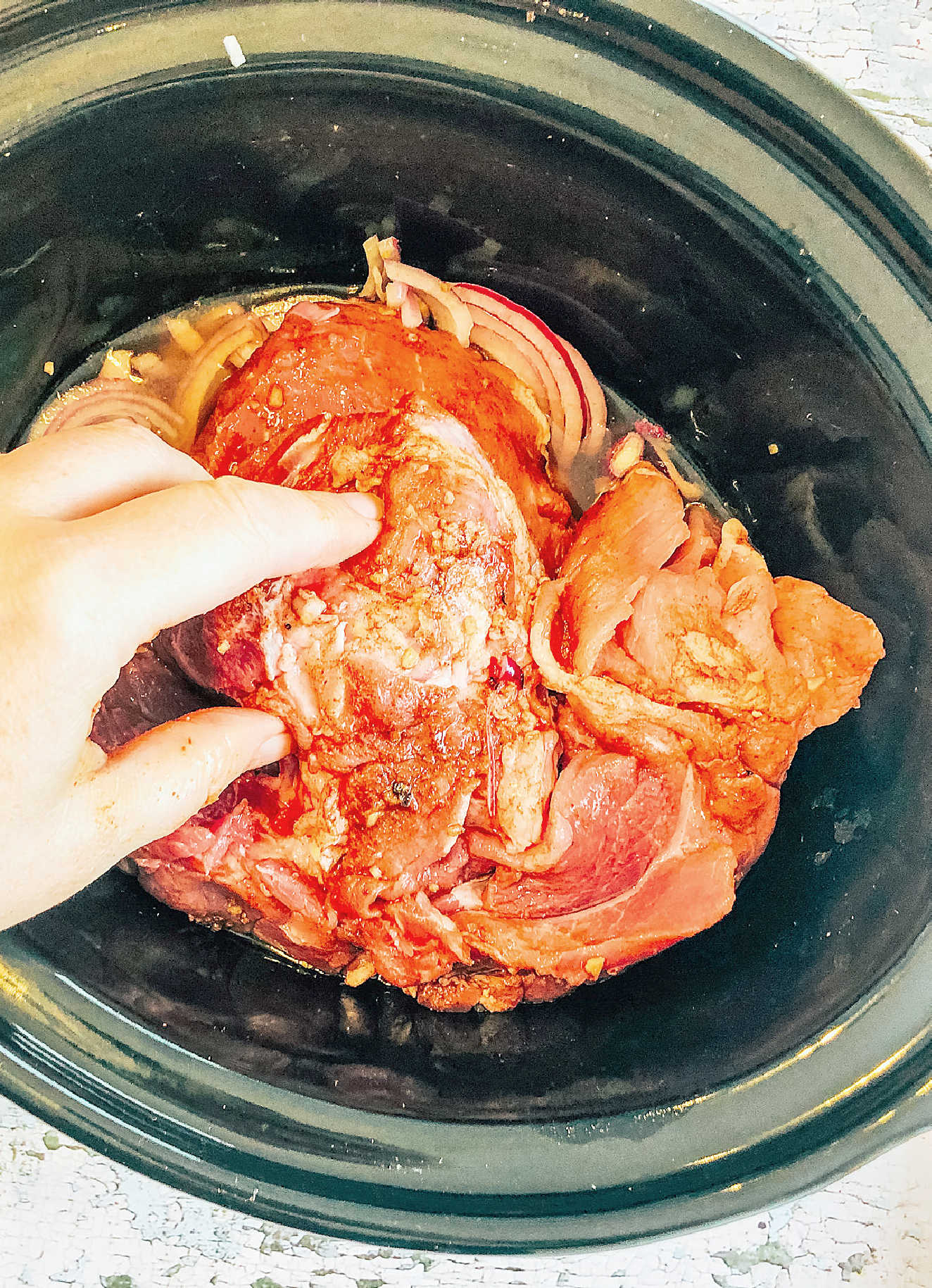 Rub the pork in all the spices and golden syrup and then add to the slow cooker and place the lid on