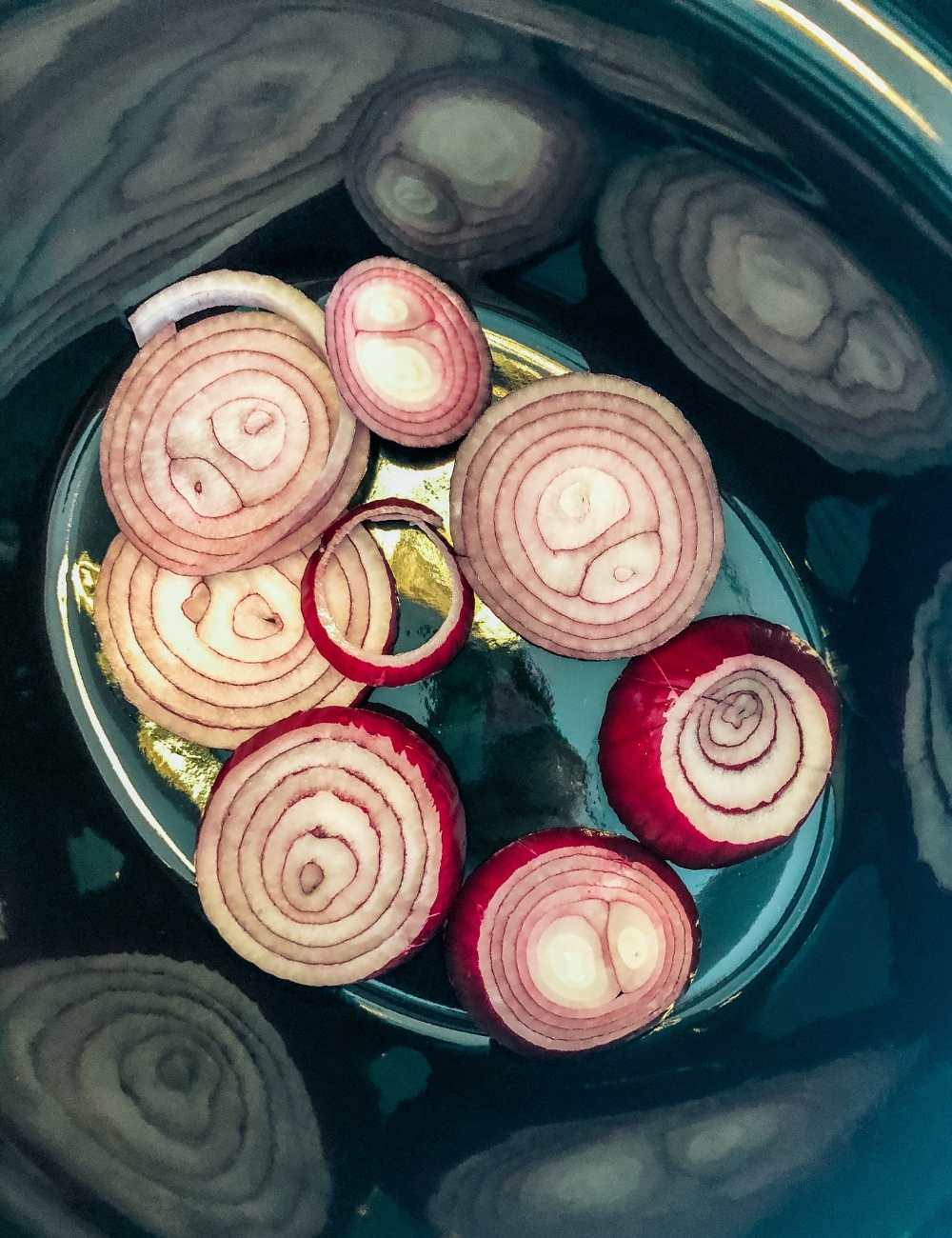 Layer the slow cooker with onions