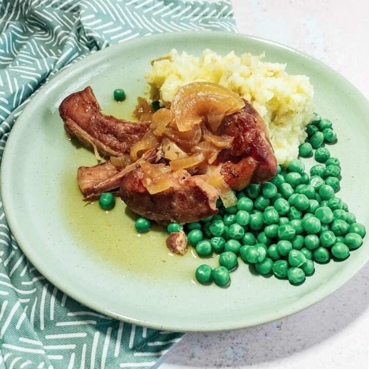 Serve the Gammon cooked in cider and onions with mash and peas