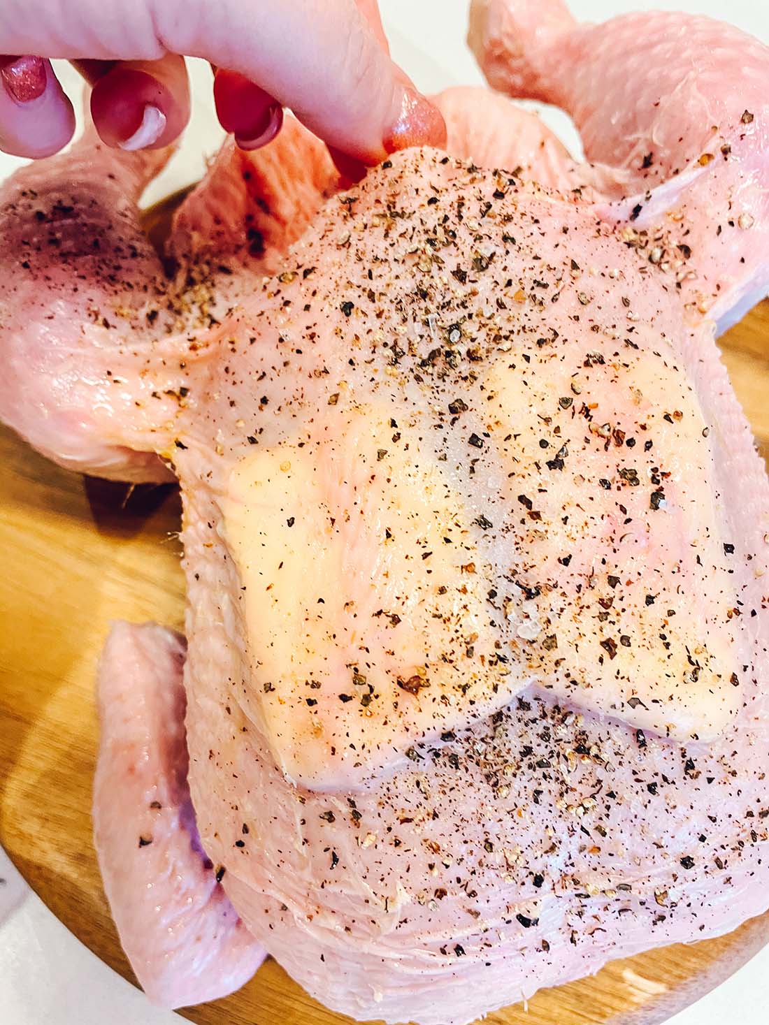Put slices of butter under the skin of the chicken and brush the skin with olive oil, salt , pepper and mixed herbs