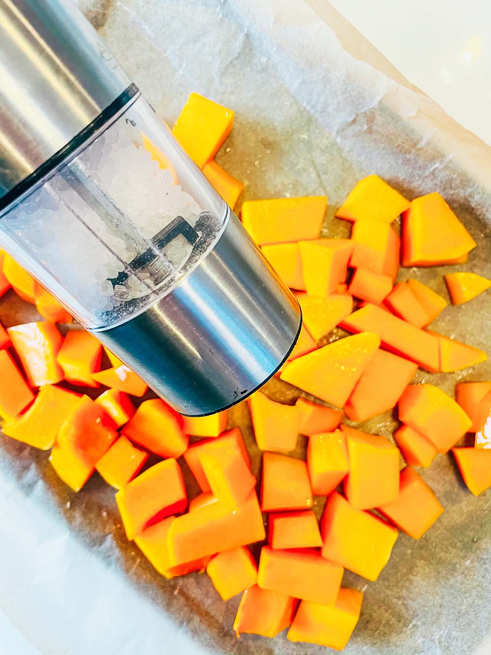 Chop the butternut sqush into chunks and toss in oil before seasonimg with salt