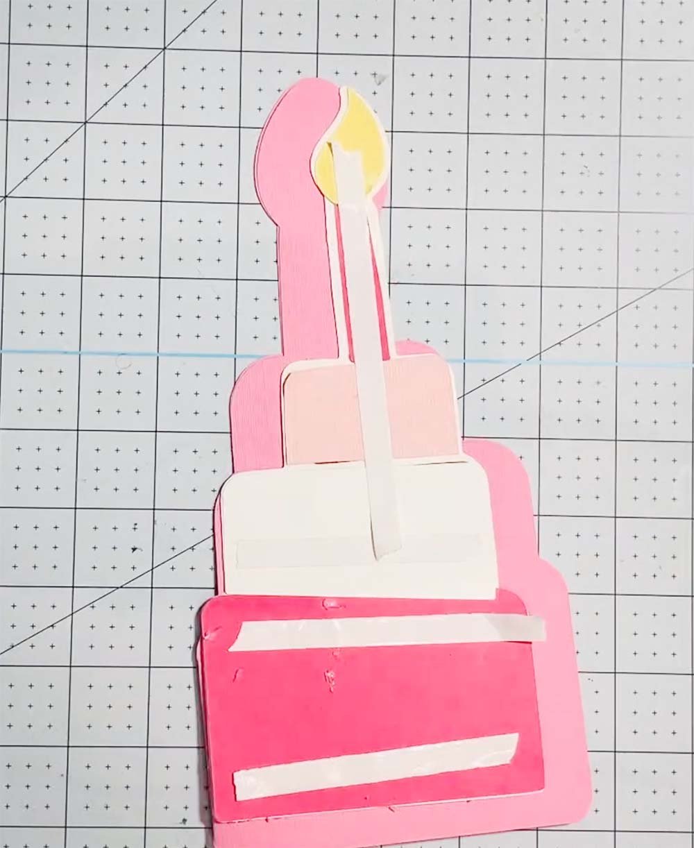 Attach double sided sticky tape to the back of your cake cut file