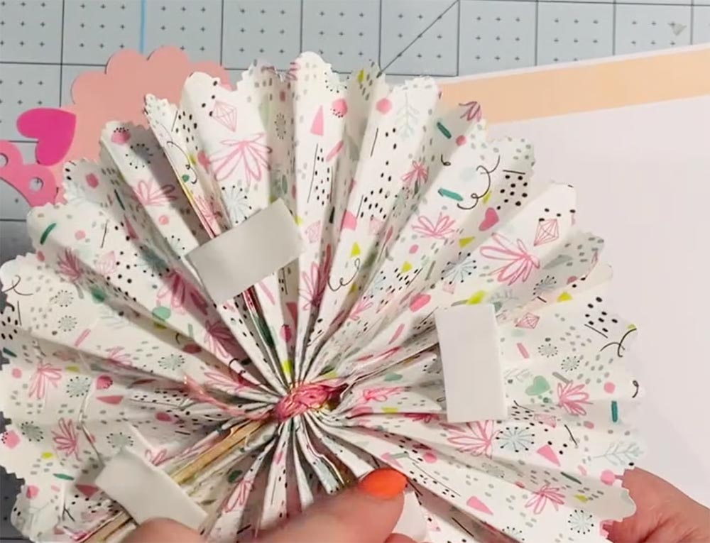 Use strong sticky pads to attach the fan to the card