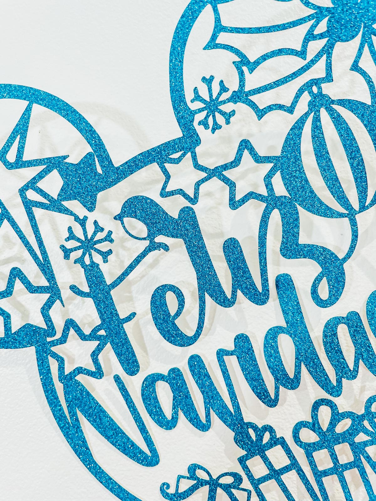 Feliz Navidad PNG SVG files for Christmas Crafting cut in blue card with Christmas details, a Robin, star and baubles